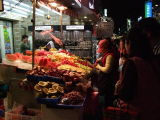 A lot of fruits on stand.